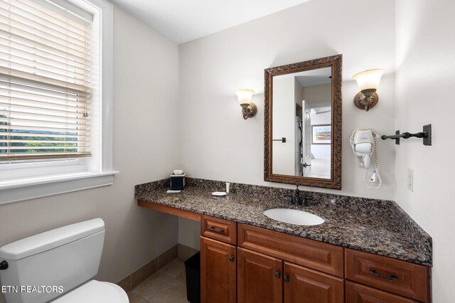 bathroom featuring tile patterned floors, vanity, and toilet