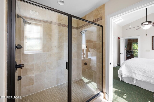 bathroom with ceiling fan, a wealth of natural light, lofted ceiling, and a shower with door