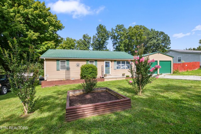 single story home featuring an outbuilding, a front lawn, and a garage