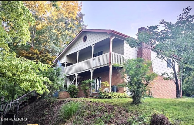 rear view of property with a balcony