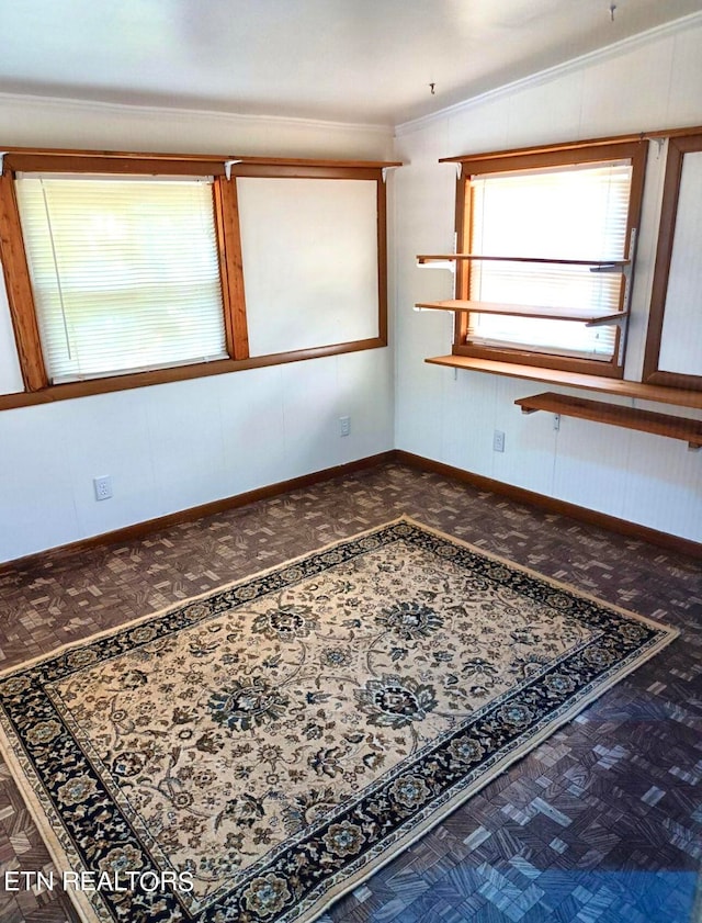 unfurnished room with vaulted ceiling and crown molding