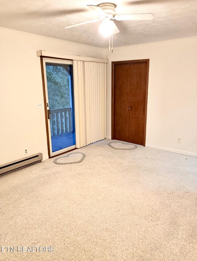 spare room with ceiling fan, carpet flooring, a textured ceiling, and baseboard heating