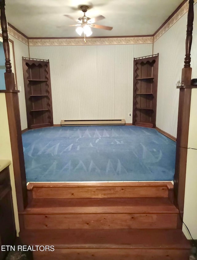 carpeted empty room with ceiling fan, a baseboard heating unit, and ornamental molding