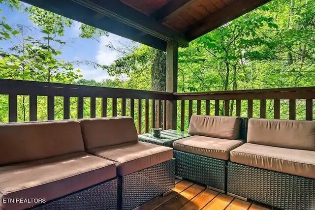 wooden terrace with an outdoor hangout area