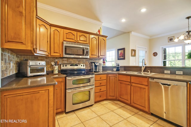 kitchen featuring tasteful backsplash, stainless steel appliances, and crown molding