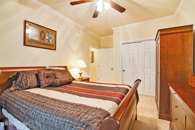 carpeted bedroom with ornamental molding, ceiling fan, and a closet