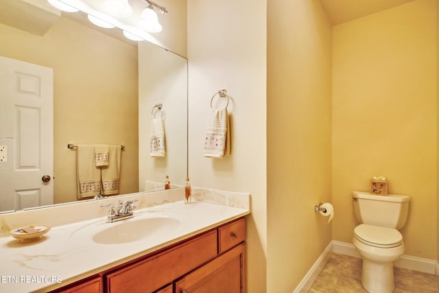 bathroom with vanity, tile patterned floors, and toilet