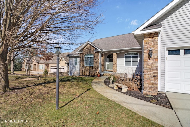 view of front of property featuring a garage and a front yard