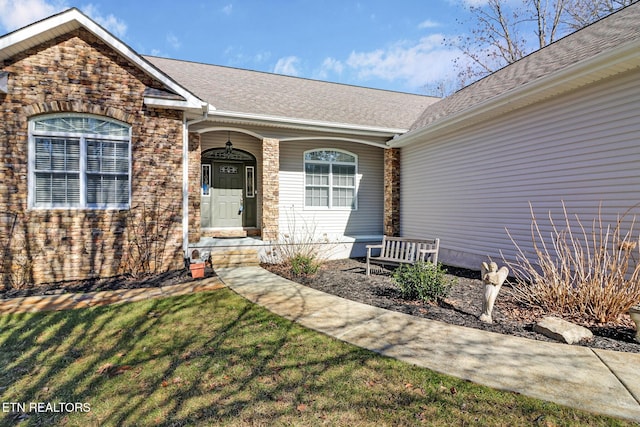 property entrance featuring a lawn