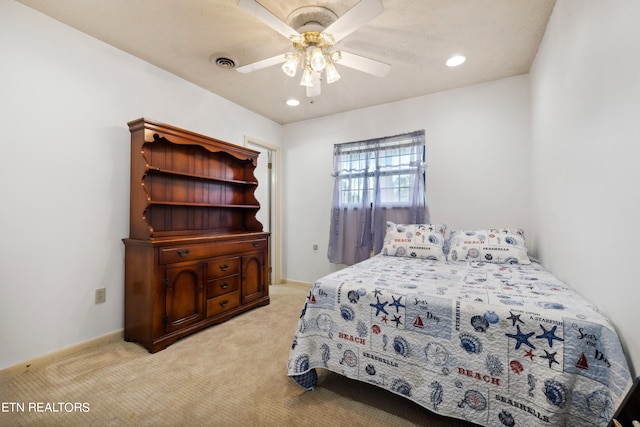 bedroom featuring ceiling fan and light carpet