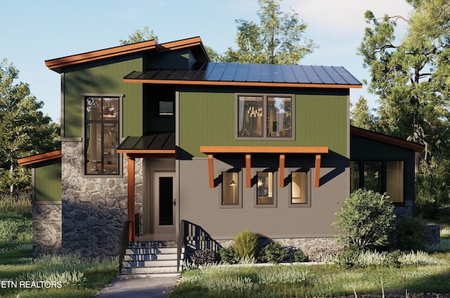 contemporary house featuring entry steps, a standing seam roof, stone siding, and metal roof