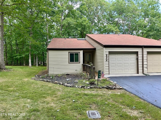 ranch-style house with a garage and a front lawn