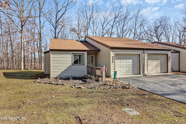 ranch-style home with a garage and a front yard