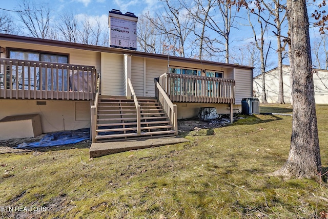 rear view of property featuring a yard, central air condition unit, and a deck