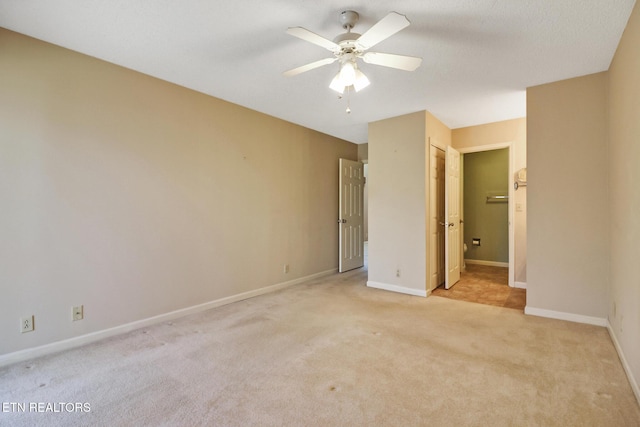 unfurnished bedroom featuring ceiling fan and light carpet