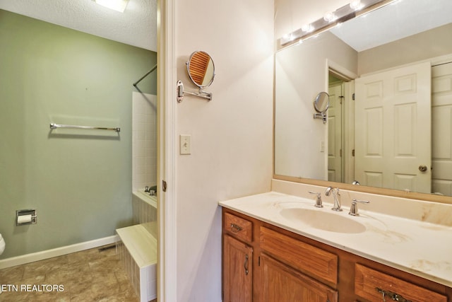 bathroom with vanity and a textured ceiling