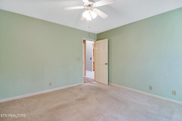 unfurnished room featuring ceiling fan and light carpet