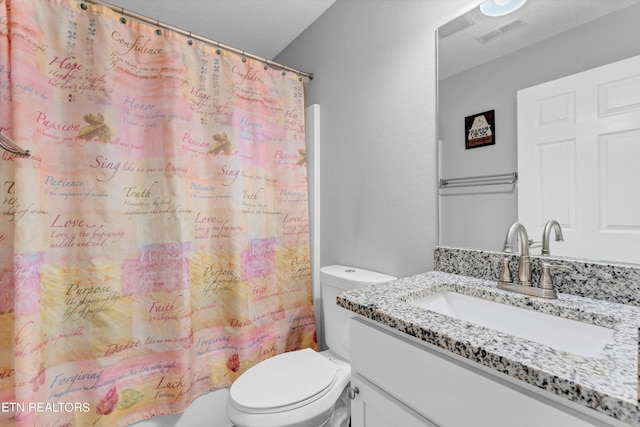 bathroom with toilet and vanity