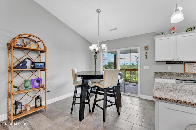 tiled dining room with vaulted ceiling and an inviting chandelier