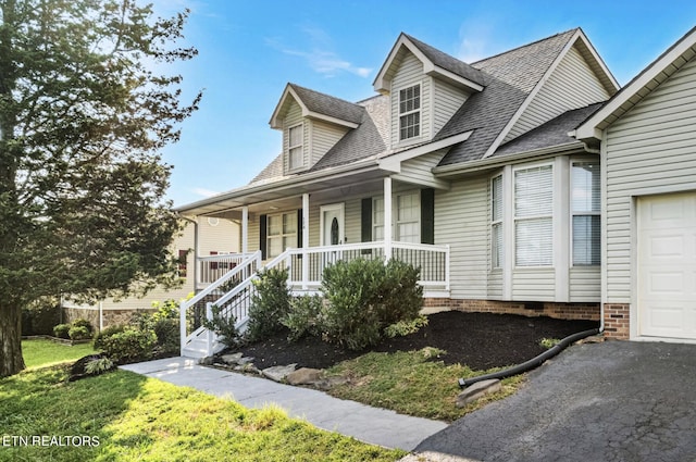 view of front facade featuring a garage and covered porch