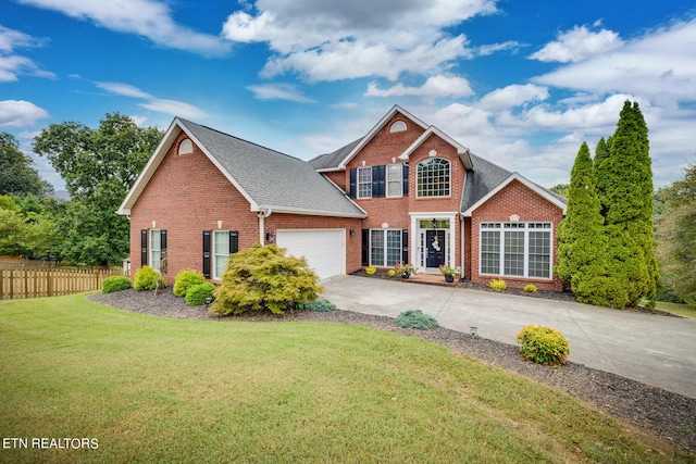 view of property featuring a front yard and a garage