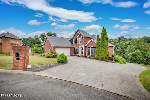 view of front property featuring a garage and a front yard