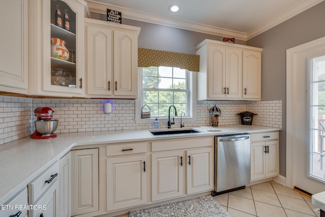 kitchen featuring a wealth of natural light, sink, backsplash, and dishwasher