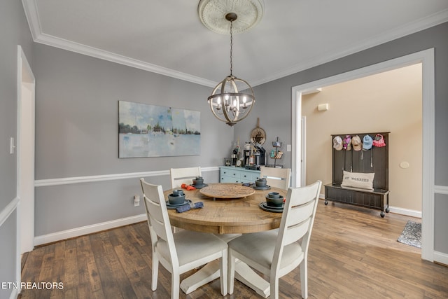 dining area featuring crown molding, wood-type flooring, and an inviting chandelier