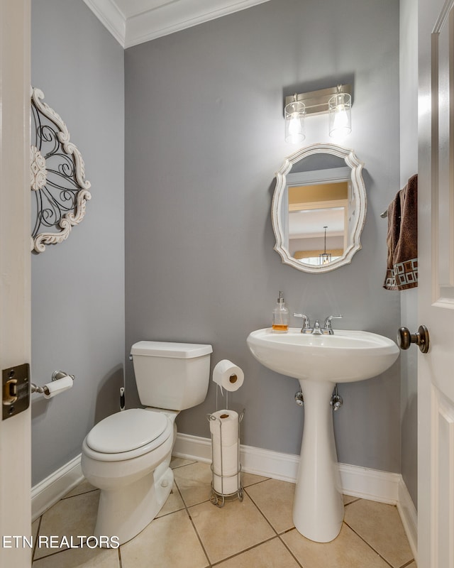 bathroom featuring tile patterned floors, crown molding, and toilet