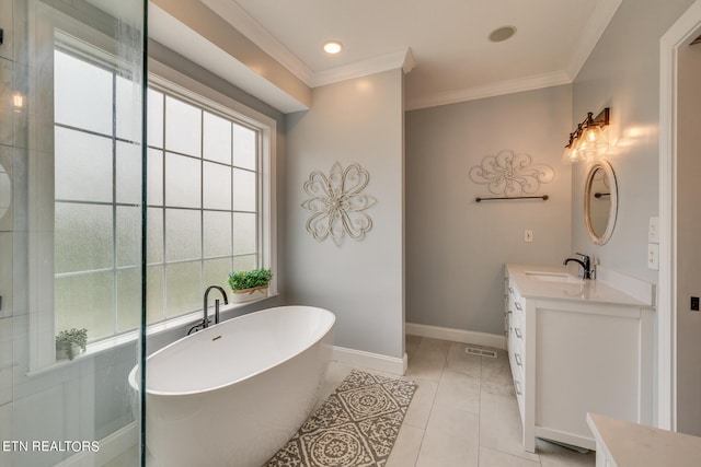 bathroom with tile patterned flooring, a washtub, vanity, and crown molding