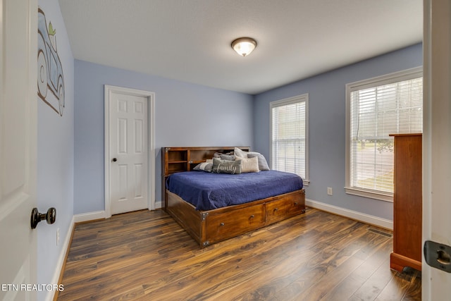 bedroom featuring dark wood-type flooring