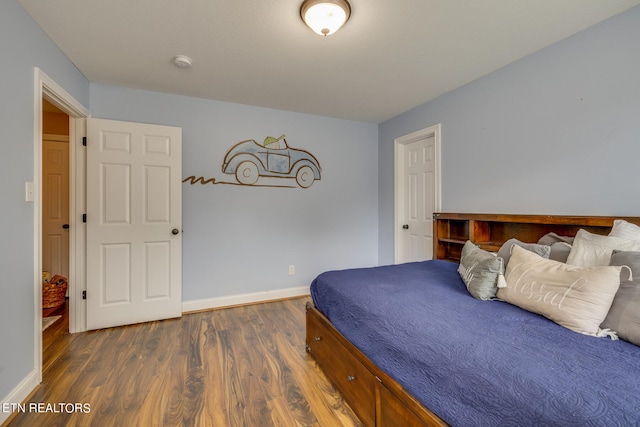 bedroom with dark hardwood / wood-style floors