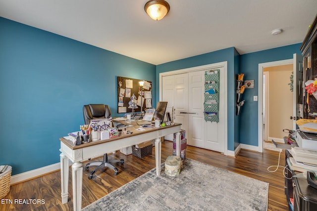 home office with dark wood-type flooring