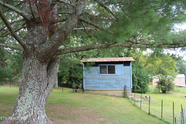 view of outbuilding with a yard