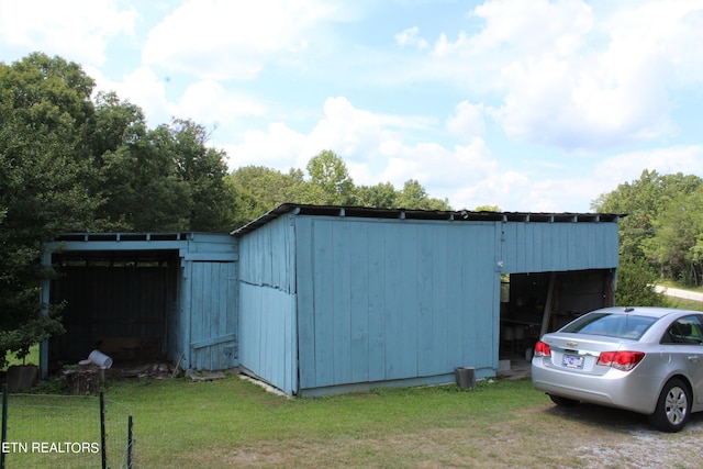 view of outbuilding with a lawn