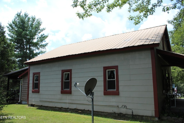 view of side of property with a yard