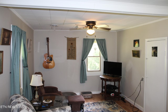 living room featuring hardwood / wood-style floors, ornamental molding, and ceiling fan