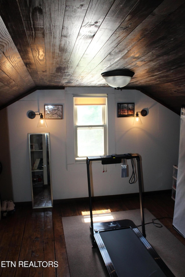 workout area featuring lofted ceiling, wooden ceiling, and dark wood-type flooring