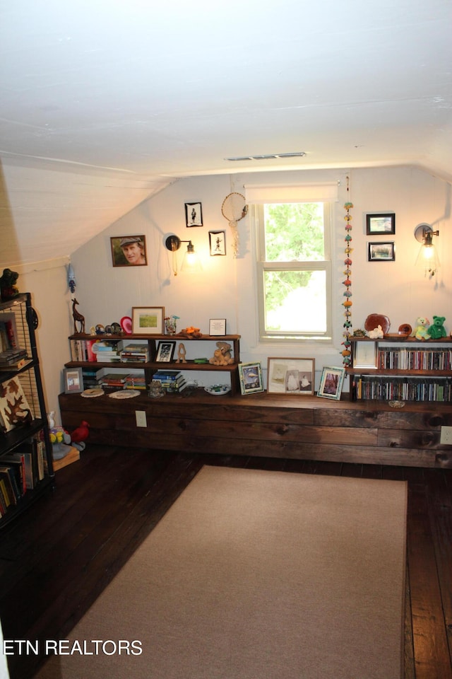 interior space featuring vaulted ceiling and hardwood / wood-style floors