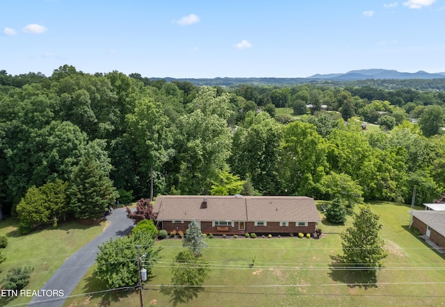 birds eye view of property featuring a mountain view and a wooded view