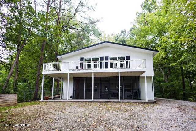 back of property featuring a wooden deck