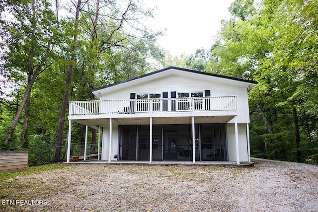 back of house featuring a sunroom and fence