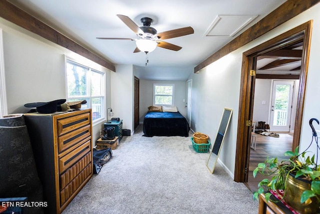 carpeted bedroom featuring ceiling fan, baseboards, and beamed ceiling