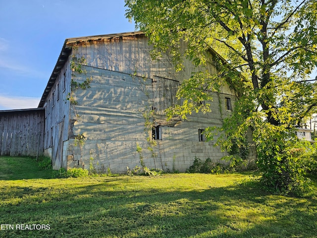 view of side of home featuring a yard