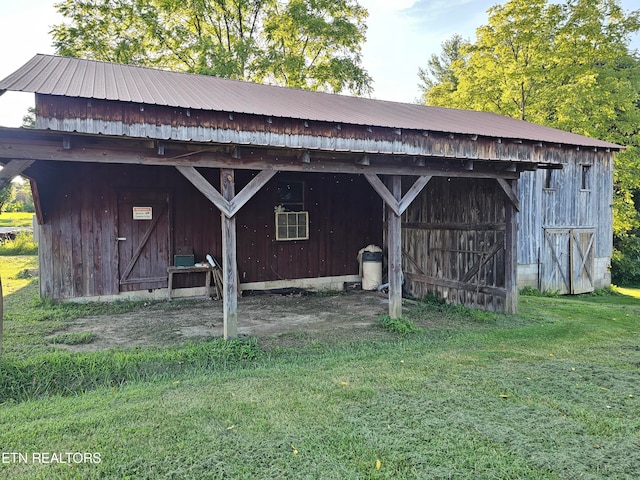 view of outbuilding with a yard