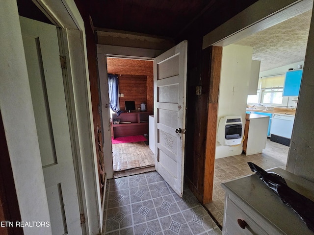 hall with tile patterned flooring and sink