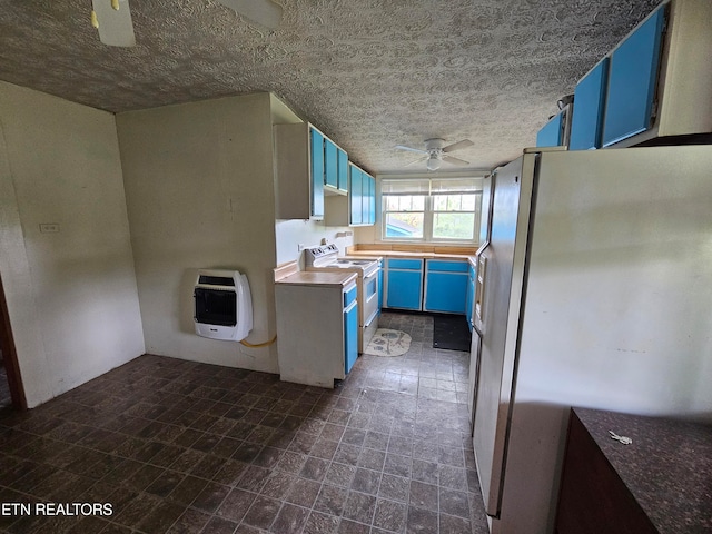 kitchen featuring ceiling fan, white electric range oven, blue cabinetry, stainless steel fridge, and dark tile patterned floors