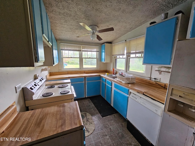 kitchen with ceiling fan, blue cabinets, a textured ceiling, lofted ceiling, and white appliances