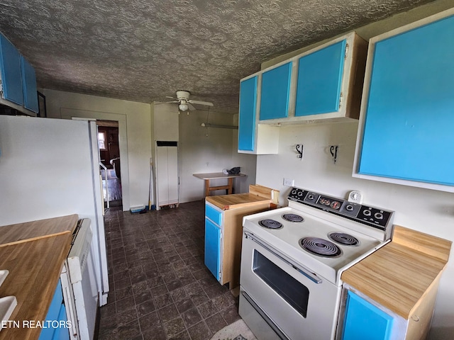 kitchen with dark tile patterned flooring, white appliances, ceiling fan, and blue cabinetry