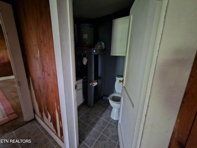 bathroom with toilet and tile patterned floors